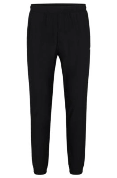 Hugo Boss Tracksuit Bottoms In Stretch Fabric With Decorative Reflective Logo In Black