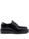 Prada Triangle Patch Leather Loafers In Black