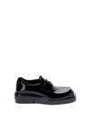 Prada Triangle Patch Leather Loafers In Black  
