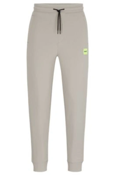 Hugo Boss Cotton-terry Tracksuit Bottoms With Red Logo Label In Light Grey
