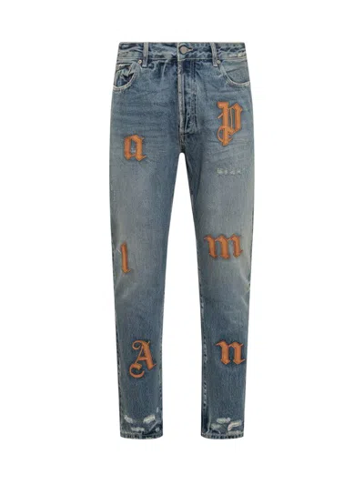 Palm Angels Logo Patch Distressed Jeans In Blue