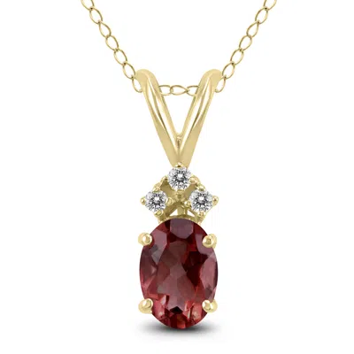 Sselects 14k 7x5mm Oval Garnet And Three Stone Diamond Pendant In Red