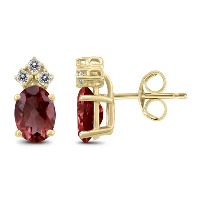 Sselects 14k 8x6mm Oval Garnet And Three Stone Diamond Earrings In Red