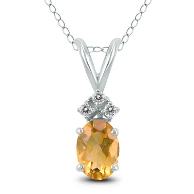 Sselects 14k 7x5mm Oval Citrine And Three Stone Diamond Pendant In Gold