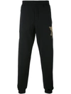 ALEXANDER MCQUEEN EMBROIDERED TRACK TROUSERS,463987QJX2312130435