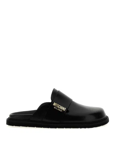 Moschino Logo Sabots Flat Shoes In Black