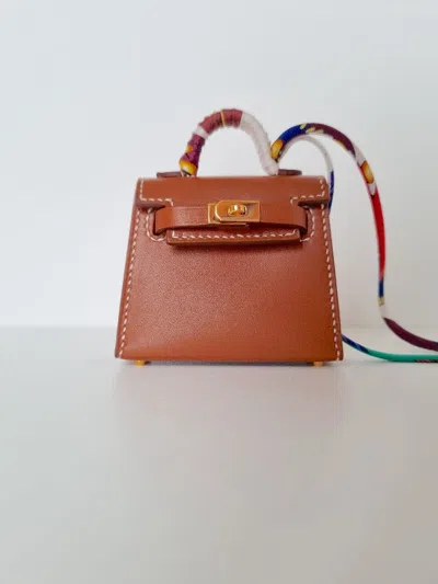 Pre-owned Hermes Hermès Fauve Vif Tadelakt Leather Mini Kelly Twilly Bag