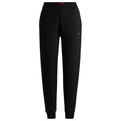 Hugo Relaxed-fit Tracksuit Bottoms With Printed Logo In Black