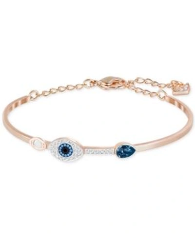 SWAROVSKI ROSE GOLD-TONE CLEAR AND BLUE CRYSTAL EVIL EYE ADJUSTABLE BANGLE BRACELET