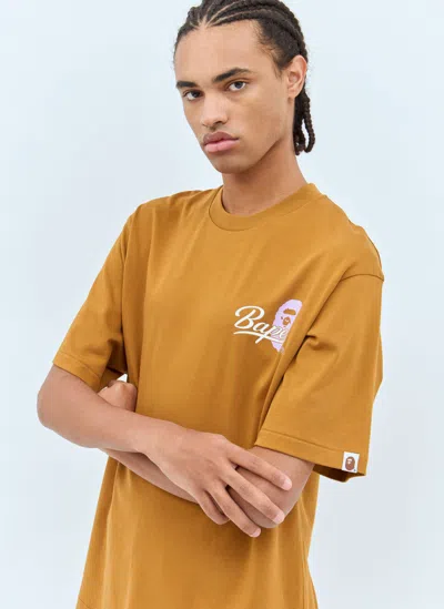 A Bathing Ape Cursive College Logo T-shirt In Mustard