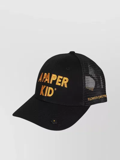 A Paper Kid Trucker Hat With Curved Brim And Embroidered Detailing In Black