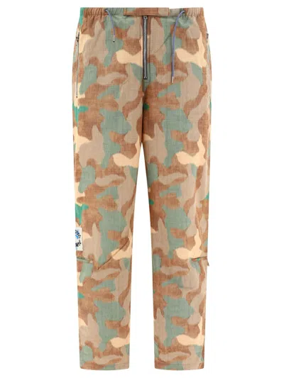 Acne Studios Camouflage Detailed Trousers In Orange/green