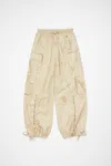 Acne Studios Relaxed Fit Printed Trousers In Oat Beige