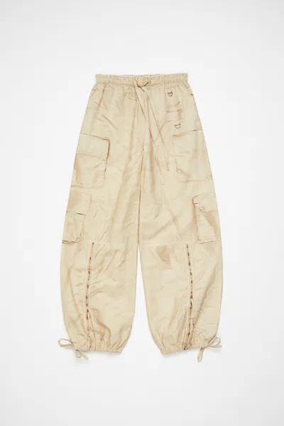 Acne Studios Relaxed Fit Printed Trousers In Oat Beige