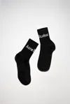 Acne Studios Ribbed Logo Socks In Black Satin,grey
