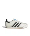 Adidas Originals Low-top Rubber Sole Sneaker With Contrast Stripes In White Core/black Core/chewing Gum