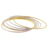 ADORNIA 14K GOLD PLATED TRI-COLOR SKINNY 7-PIECE BANGLE SET