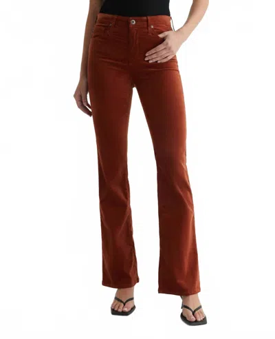 Ag Farrah Boot Velvet Mid-rise Jeans In Spiced Maple In Red