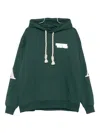 Al Ain Loose Fit Hoodie With Braided Drawstrings And Bold Graphics In Green