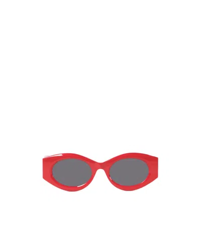 Alaïa Oval Frame Sunglasses In Gray