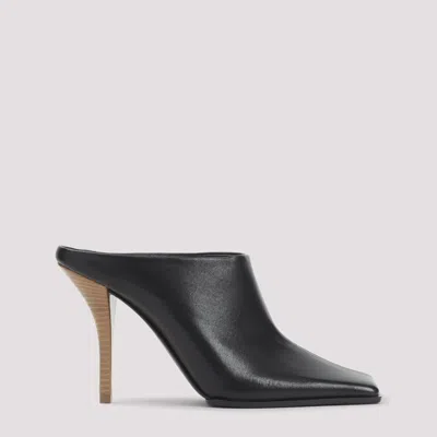 Alaïa Elegant Flat 90 Mules For Women In Black
