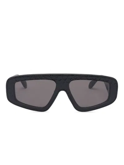 Alaïa Eyewear Geometrische Sonnenbrille Mit Lederdetails In Schwarz
