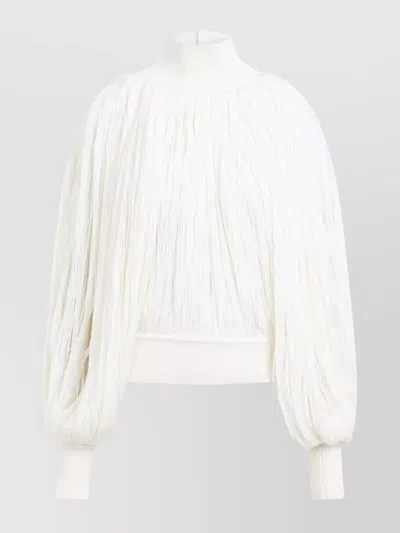 ALAÏA FRINGED HIGH NECK JUMPER