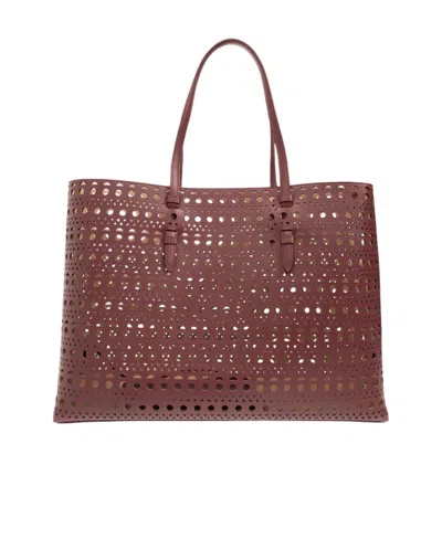 Alaïa Hollowed-out Shoulder Bag In Red