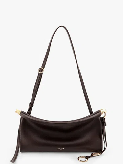 Alaïa Le Click East West Small Leather Crossbody Bag In Brown
