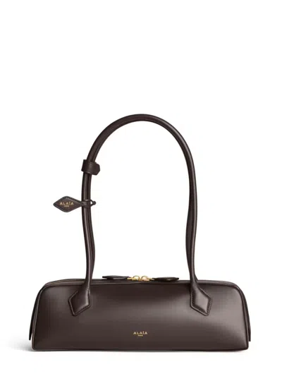Alaïa Le Teckel Medium Shoulder Handbag With Elongated Silhouette And Double Zip In Brown
