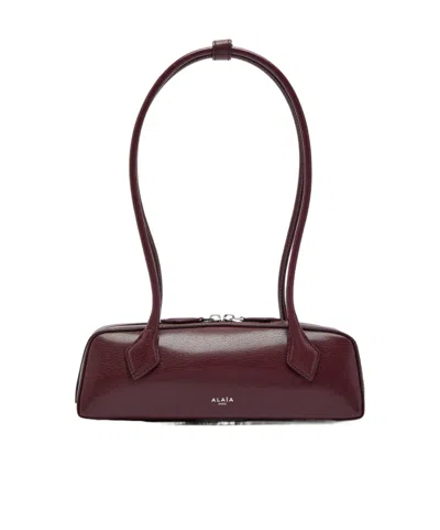 Alaïa Le Teckel Small Grained Leather Shoulder Bag In Burgundy