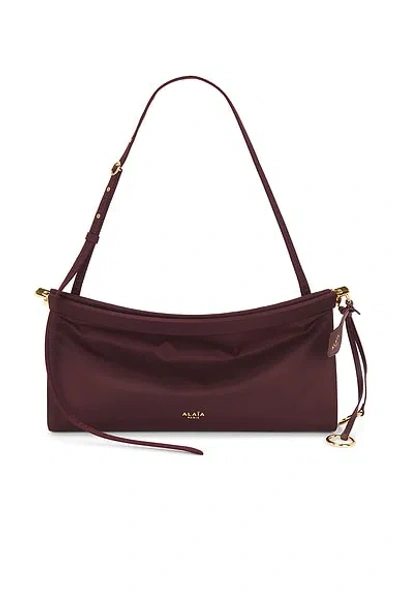 Alaïa Medium Leather Le Click East West Shoulder Bag In Burgundy