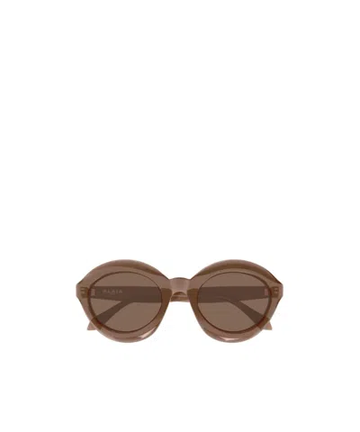 Alaïa Oval Frame Sunglasses In Brown