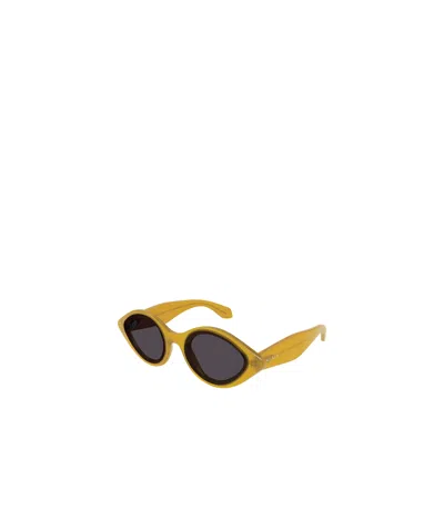 Alaïa Oval-frame Tinted Sunglasses In Yellow