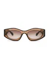 Alaïa Oval Sunglasses In Brown