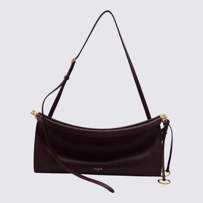 Alaïa Red Leather East West Medium Crossbody Bag In Burgundy
