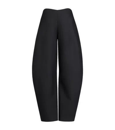 Alaïa Round Wool Crepe Barrel-leg Pants In Black