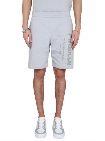 ALEXANDER MCQUEEN BERMUDA SHORTS WITH GRAFFITI LOGO PRINT