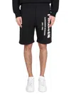 ALEXANDER MCQUEEN BERMUDA SHORTS WITH GRAFFITI LOGO PRINT