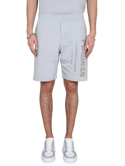 Alexander Mcqueen Men Bermuda Shorts With Graffiti Logo Print In Blue