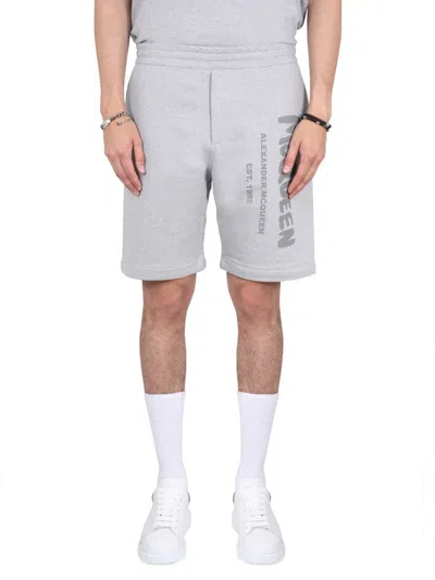 ALEXANDER MCQUEEN ALEXANDER MCQUEEN BERMUDA SHORTS WITH GRAFFITI LOGO PRINT
