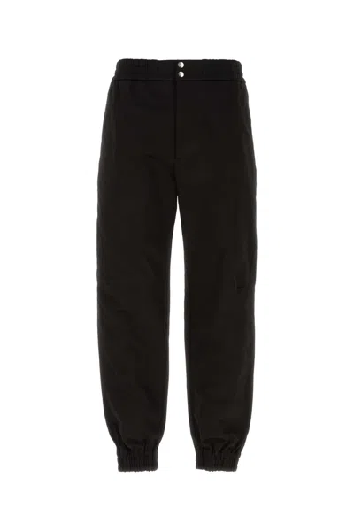 Alexander Mcqueen Men Printed Trousers In Black