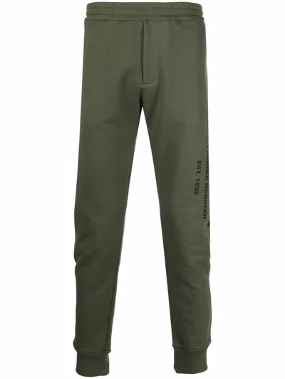 Alexander Mcqueen Logo Print Tapered Track Trousers In Grün