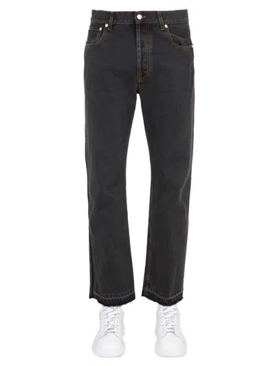 Alexander Mcqueen Raw Cut Jeans In Black