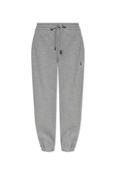 Alexander Mcqueen Skull Embroidered Tapered Sweatpants In Grey