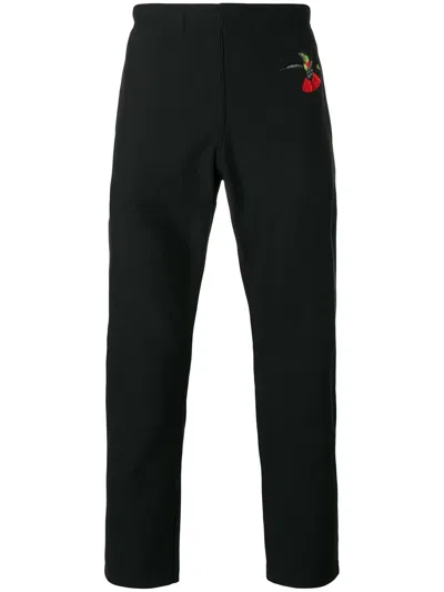 Alexander Mcqueen Swallow Print Tapered Trousers In Black