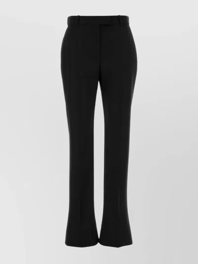 ALEXANDER MCQUEEN TAILORED WOOL TROUSERS FEATURING FLARED HEM