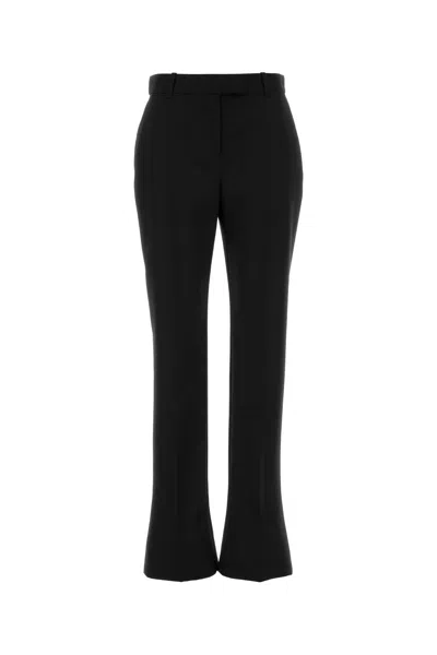Alexander Mcqueen Tailored Wool Trousers Featuring Flared Hem In Black