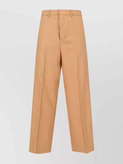 AMI ALEXANDRE MATTIUSSI TAILORED TROUSERS WITH BUTTON AND PLEATS