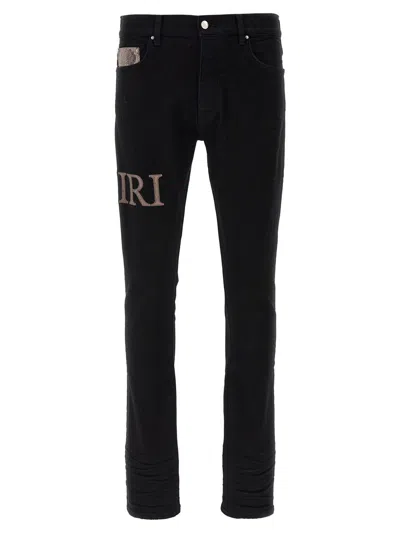 Amiri Snake Logo Distressed Jeans In Black